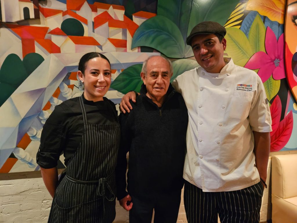 Mercadito Collaboration with the International Latino Cultural Center of Chicago - Pepe Vargas poses with Executive Chef Carlos Garza and Chef Zoey Bryant